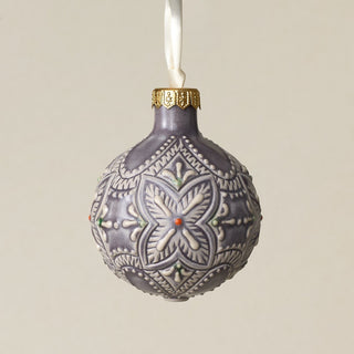 Intricately carved and glazed ceramic globe ornament with ivory satin ribbon –