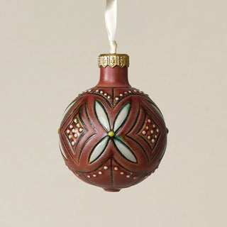 Intricately carved and glazed ceramic globe ornament with ivory satin ribbon –