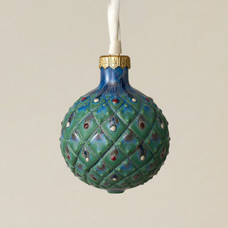 Intricately carved and glazed ceramic globe ornament with ivory satin ribbon –