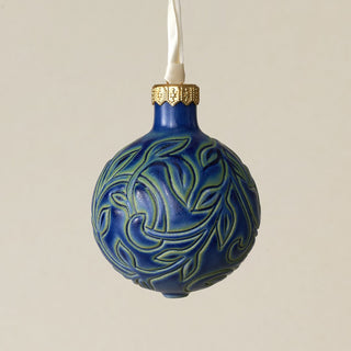 Intricately carved and glazed ceramic globe ornament with ivory satin ribbon –