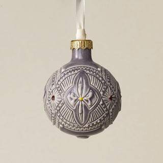 Intricately carved and glazed ceramic globe ornament with ivory satin ribbon –