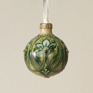Intricately carved and glazed ceramic globe ornament with ivory satin ribbon –