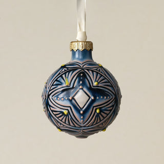 Intricately carved and glazed ceramic globe ornament with ivory satin ribbon –