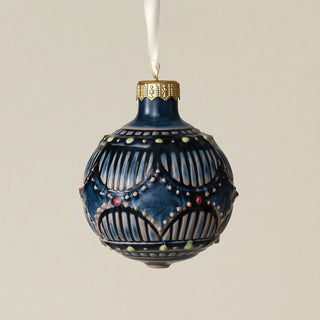 Intricately carved and glazed ceramic globe ornament with ivory satin ribbon –