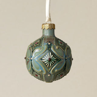 Intricately carved and glazed ceramic globe ornament with ivory satin ribbon –