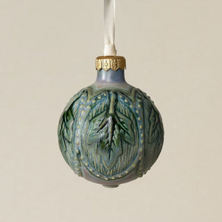 Intricately carved and glazed ceramic globe ornament with ivory satin ribbon –