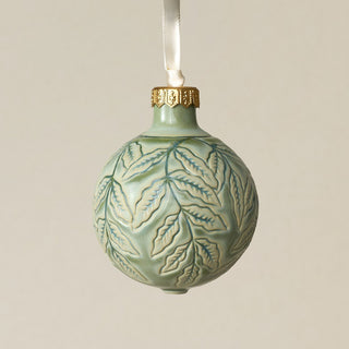 Intricately carved and glazed ceramic globe ornament with ivory satin ribbon –