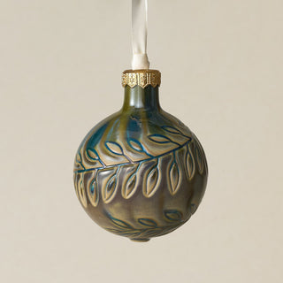 Intricately carved and glazed ceramic globe ornament with ivory satin ribbon –
