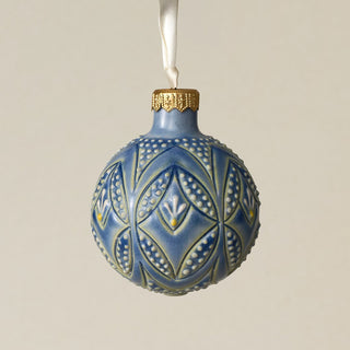 Intricately carved and glazed ceramic globe ornament with ivory satin ribbon –