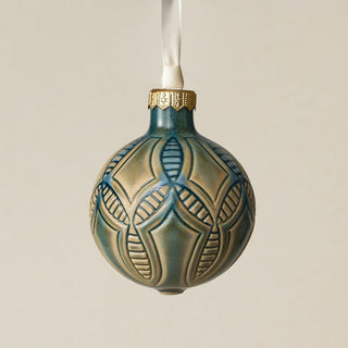 Intricately carved and glazed ceramic globe ornament with ivory satin ribbon –
