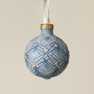Intricately carved and glazed ceramic globe ornament with ivory satin ribbon –