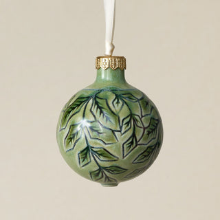Intricately carved and glazed ceramic globe ornament with ivory satin ribbon –
