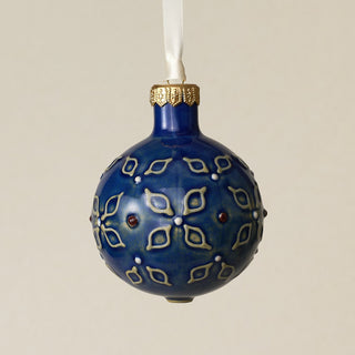 Intricately carved and glazed ceramic globe ornament with ivory satin ribbon –