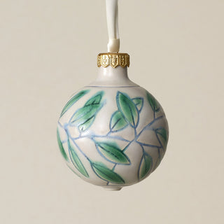 Intricately carved and glazed ceramic globe ornament with ivory satin ribbon –