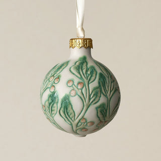 Intricately carved and glazed ceramic globe ornament with ivory satin ribbon –
