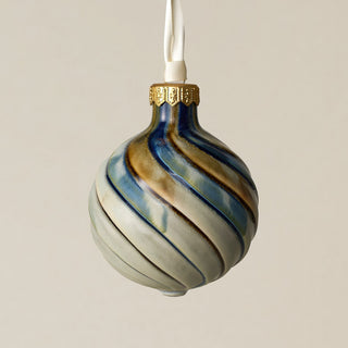 Intricately carved and glazed ceramic globe ornament with ivory satin ribbon –