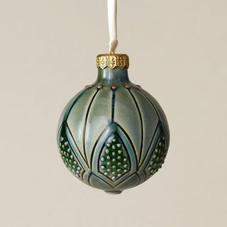 Intricately carved and glazed ceramic globe ornament with ivory satin ribbon –