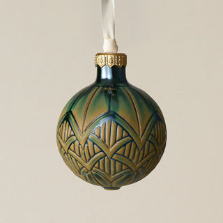 Intricately carved and glazed ceramic globe ornament with ivory satin ribbon –