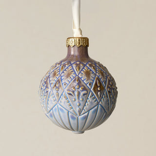 Intricately carved and glazed ceramic globe ornament with ivory satin ribbon –