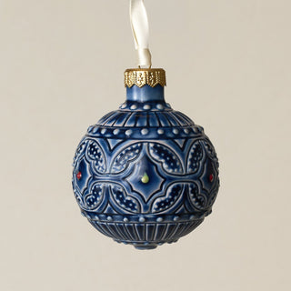 Intricately carved and glazed ceramic globe ornament with ivory satin ribbon –