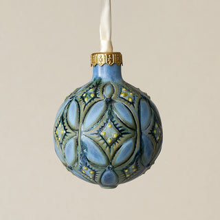 Intricately carved and glazed ceramic globe ornament with ivory satin ribbon –