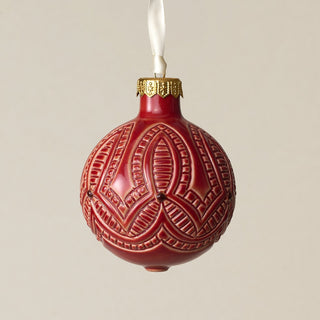 Intricately carved and glazed ceramic globe ornament with ivory satin ribbon –