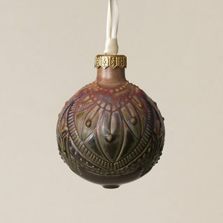 Intricately carved and glazed ceramic globe ornament with ivory satin ribbon –