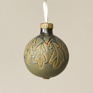 Intricately carved and glazed ceramic globe ornament with ivory satin ribbon – Ornament No. 322