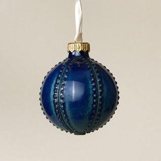 Intricately carved and glazed ceramic globe ornament with ivory satin ribbon – Ornament No. 402