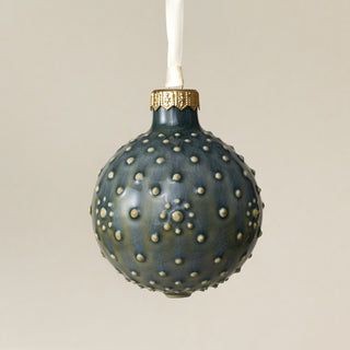 Intricately carved and glazed ceramic globe ornament with ivory satin ribbon – Ornament No. 405