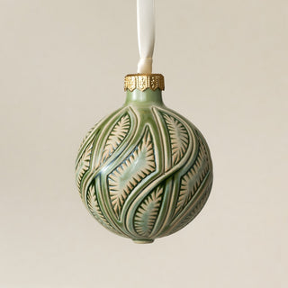 Intricately carved and glazed ceramic globe ornament with ivory satin ribbon – Ornament No. 423