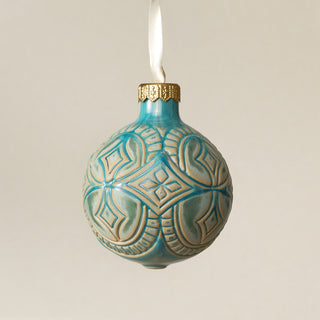 Intricately carved and glazed ceramic globe ornament with ivory satin ribbon – Ornament No. 473