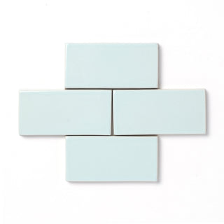 Inspired by the Alpine mountaintops, this cool neutral glaze presents a slight variation in color and features a hint of powder blue, reflective high gloss surface, and typically opaque break along relief details and tile edges.