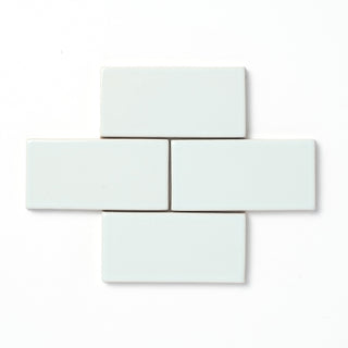 Apex is inspired by the peak of a mountaintop and has slight variation in its pale blue color, features a reflective high-gloss surface texture, and presents an opaque edge break along the tile perimeter and relief detailing.