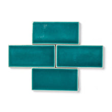 Load image into Gallery viewer, Hanauma Bay is a vibrant teal blue-green glaze that features a high-gloss surface texture with a uniquely formed crackle finish and a transparent break along tile edges and relief details.
