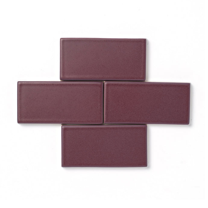 This deep purple glaze offers a consistent color, smooth surface texture and opaque break along tile edges and relief details.