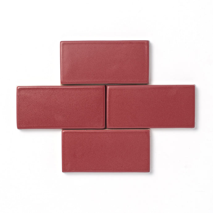 An unexpected muted rose-colored hue, Raspberry Rose features slight variation in color, a smooth matte surface texture, and an opaque break along tile edges and relief details.