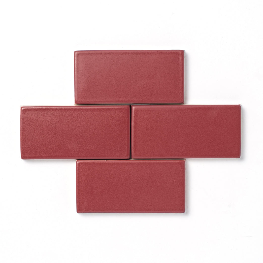An unexpected muted rose-colored hue, Raspberry Rose features slight variation in color, a smooth matte surface texture, and an opaque break along tile edges and relief details.